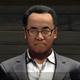 A video game version of the Square Enix CEO looks directly at the camera.